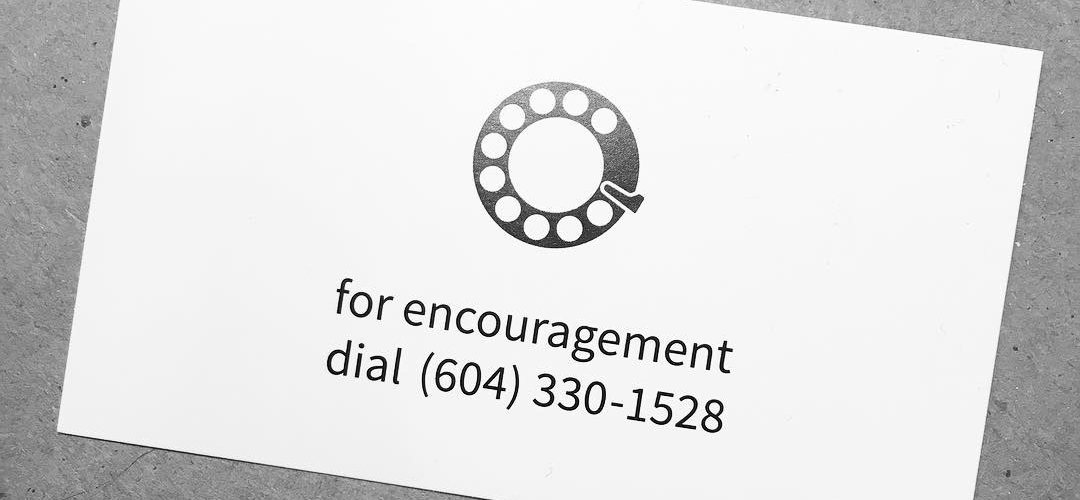 A business card for the hotline. The logo is an illustration of a rotary telephone dial.